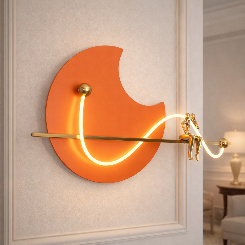 Artistic LED Wall Light with sculptural gold figures and ambient glow, ideal for luxury interiors and modern wall décor.