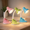 FlexiGlow adjustable colorful desk lamps in pink, green, and blue with flexible necks and LED lights on a wooden desk. Ideal for kids' study areas.