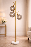 Luxury Glass Globe Floor Lamp - Aura Trio by ImperialKart with three smoked glass globes, gold metal frame, and white marble base. Ideal for modern interiors.