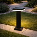 LumaPath modern outdoor bollard light with square top, illuminating a garden pathway with energy-efficient LED glow. Durable design for landscape lighting.