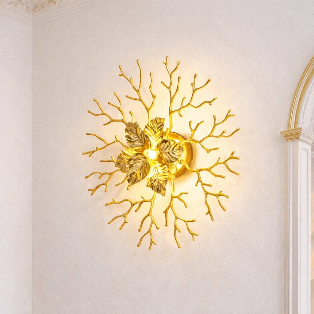 Gold Wall Sconce India with sculptural leaf and branch design, ideal for luxury decor lighting in elegant interior spaces.