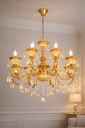 Luxury Crystal Chandelier for Living Room India with elegant gold finish and LED candle-style lights, ideal for upscale interiors and villas.