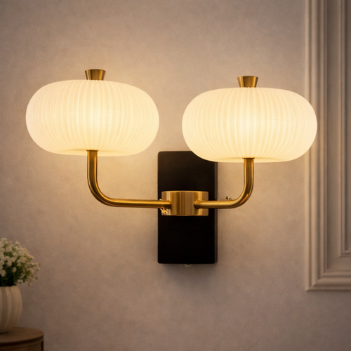 Aurelia Duo – Luxury Wall Sconce Gold Finish with dual frosted glass shades and energy-efficient LED lighting, mounted on a modern wall.