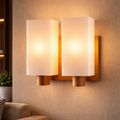 LumaWood Duo – Dual Frosted Glass Wall Sconce with warm ambient lighting and modern wood base, ideal for living rooms or bedrooms.