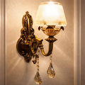 Imperial Aurelia Luxury Gold Crystal Wall Sconce with ornate brass finish and teardrop crystals, ideal for elegant home lighting décor.