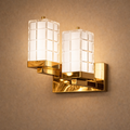 Crystaluxe Duo luxury designer wall light with dual crystal shades and polished brass finish. Ideal for modern interiors with soft ambient lighting.