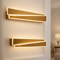 Modern Gold LED Wall Light with sleek geometric design, mounted on a luxury interior wall. Elegant illumination for upscale home decor.