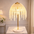 Aurora Crystal LED Lamp with cascading crystal beads and gold finish on marble base. Luxury LED Table Lamp for elegant home lighting decor.