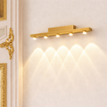 Premium wall sconce gold finish with five LED lights, mounted on a beige wall. Elegant design ideal for modern interiors and luxury decor.