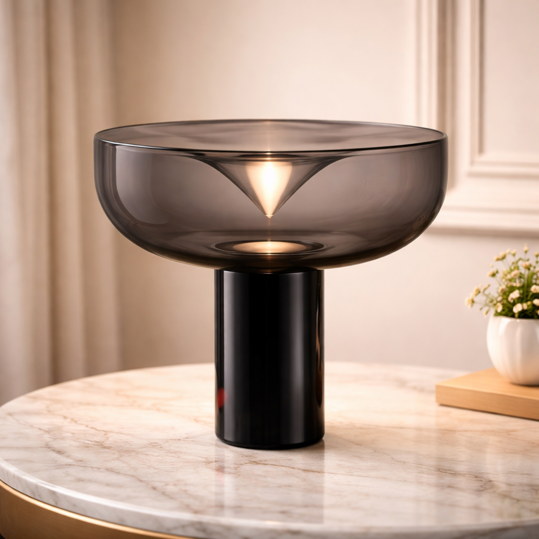 AuraBowl smoked glass LED table lamp with sculptural bowl design on a marble surface. Ideal for modern interiors with warm ambient glow.