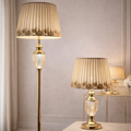 Luxury floor lamp set with crystal body and gold finish, featuring pleated beige lampshades for elegant interiors and warm ambient lighting.