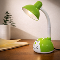 PlayGlow cute kids desk lamp in green with a cat face design, flexible neck, and soft eye-friendly light, ideal for study desks and bedrooms.