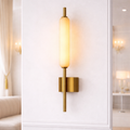 Gold wall sconce for luxury interiors in India with a sleek vertical design and warm ambient lighting, ideal for upscale homes and hotels.