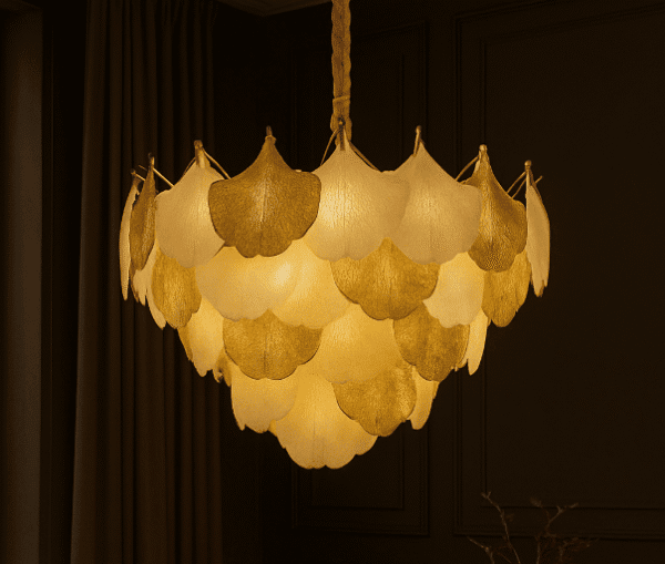 Luxury chandelier with layered gold and white flower-shaped lampshades hanging in a sophisticated interior setting.